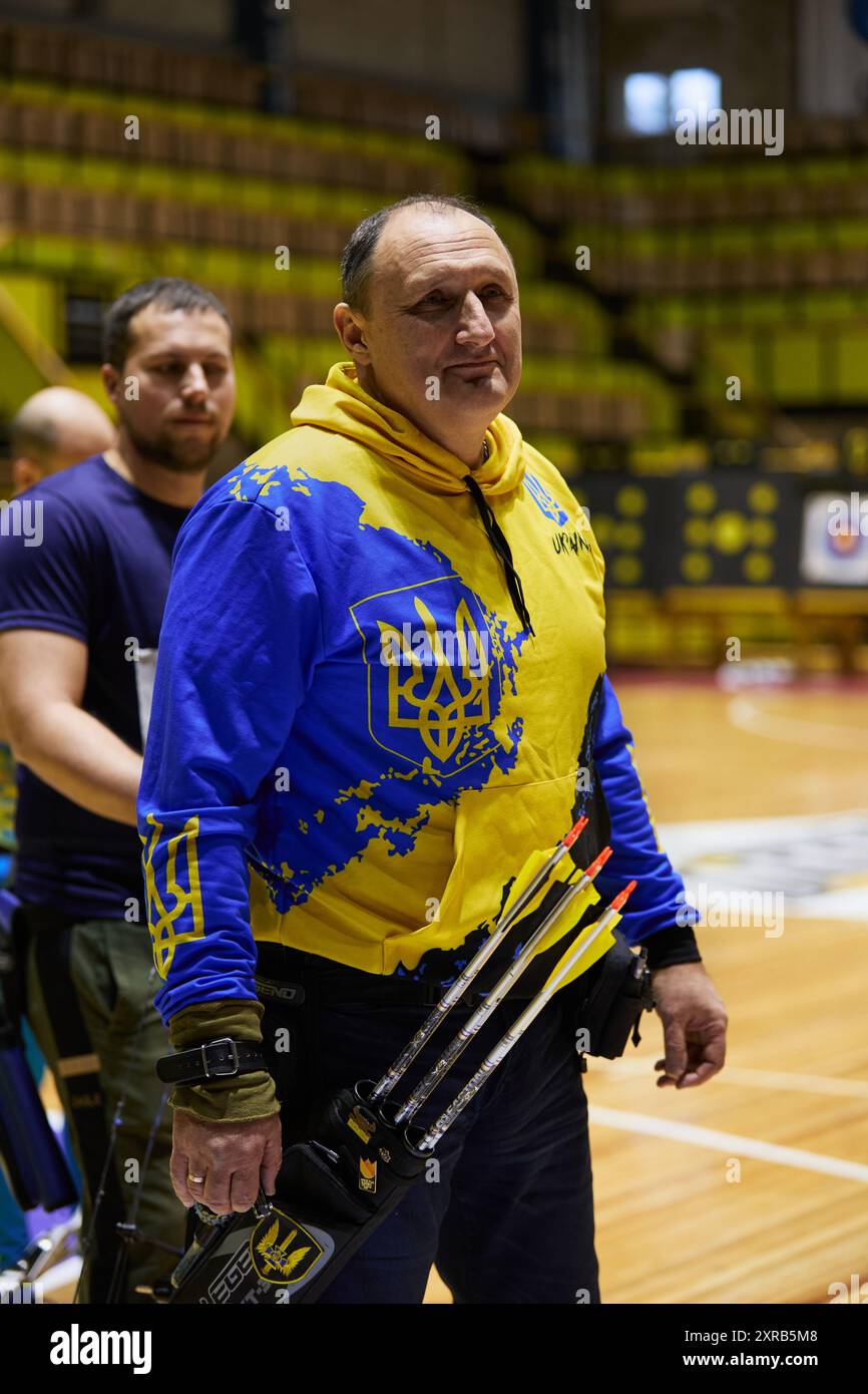 Ukrainian archer in patriotic uniform compete in para archery in Kyiv - 14 December,2023 Stock Photo