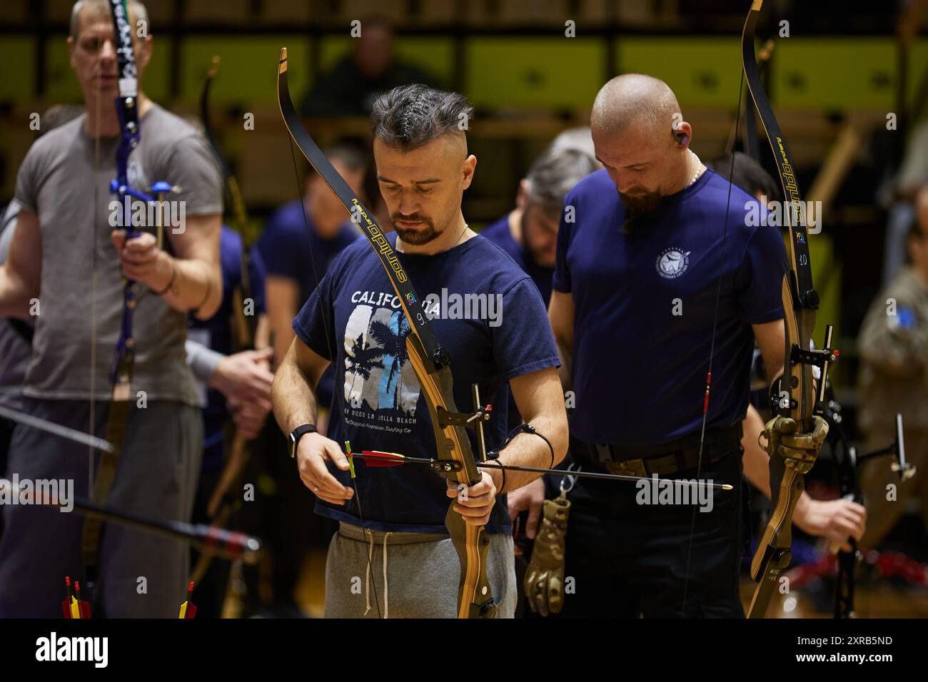 Ukrainian veteran prepares to shoot with bow. Para archery competition in Kyiv - 14 December,2023 Stock Photo