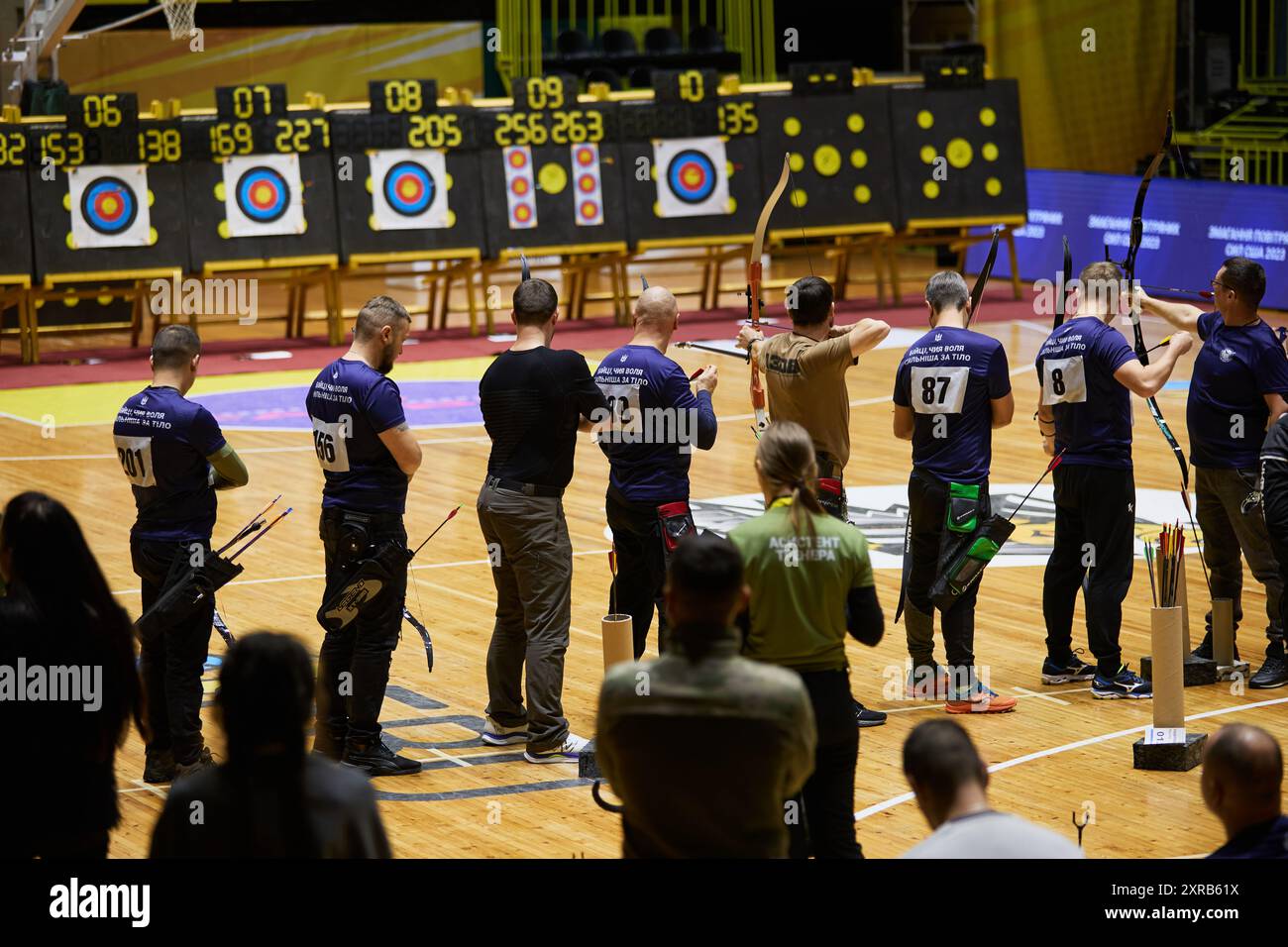 Group of Ukrainian veterans shooting targets with bow and arrow during adaptive archery competition. Kyiv - 14 December,2023 Stock Photo