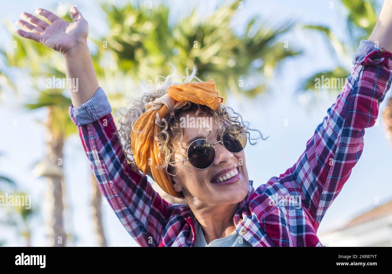 Excited pretty young trendy woman outdoor enjoy summer lifestyle - travel female people single life concept with cheerful lady enjoying and having fun - happiness and joyful emotions concept Stock Photo