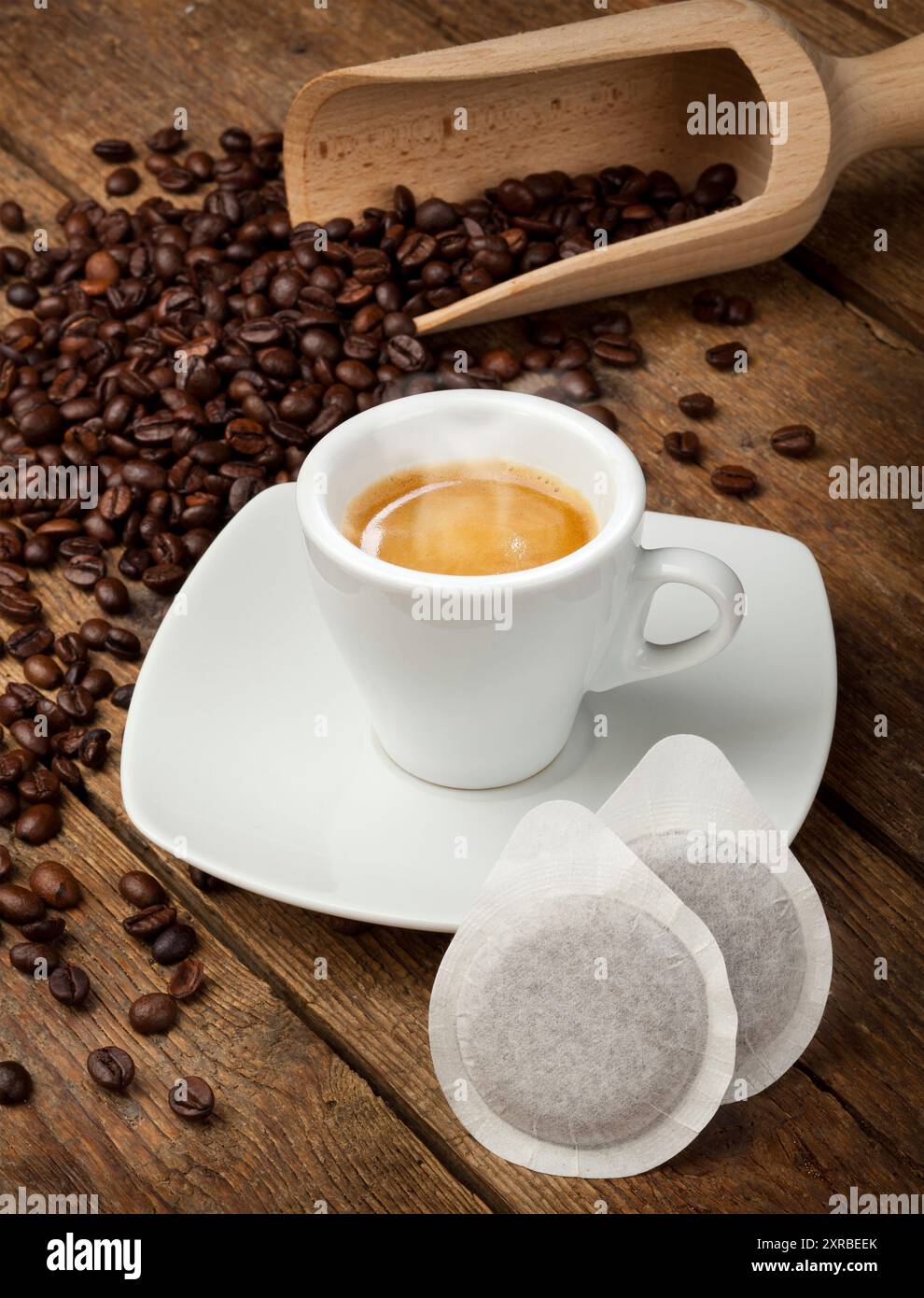 Coffee cups with pods on rustic table Stock Photo