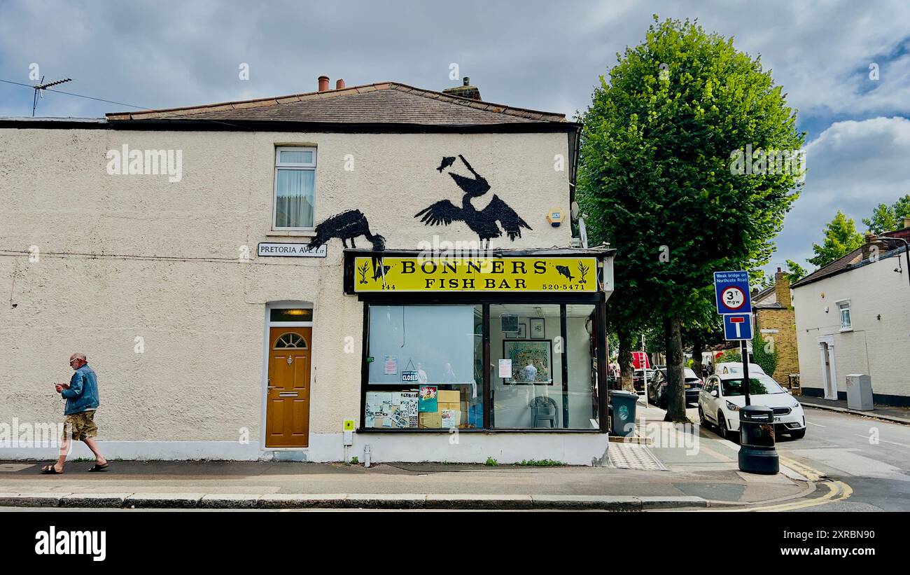 An artwork by mystery street artist Banksy appeared above a fish and chip shop in Walthamstow, east London, UK Stock Photo