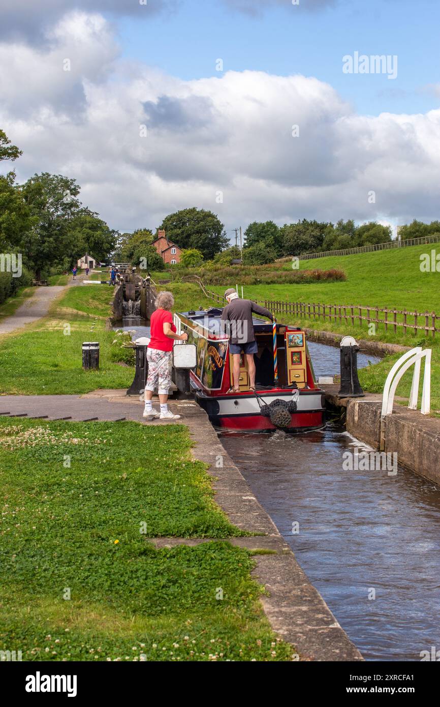 Canal narrowboat passing through Hurleston locks Cheshire on the Llangollen canal  after leaving the Shropshire union canal at its junction. Stock Photo