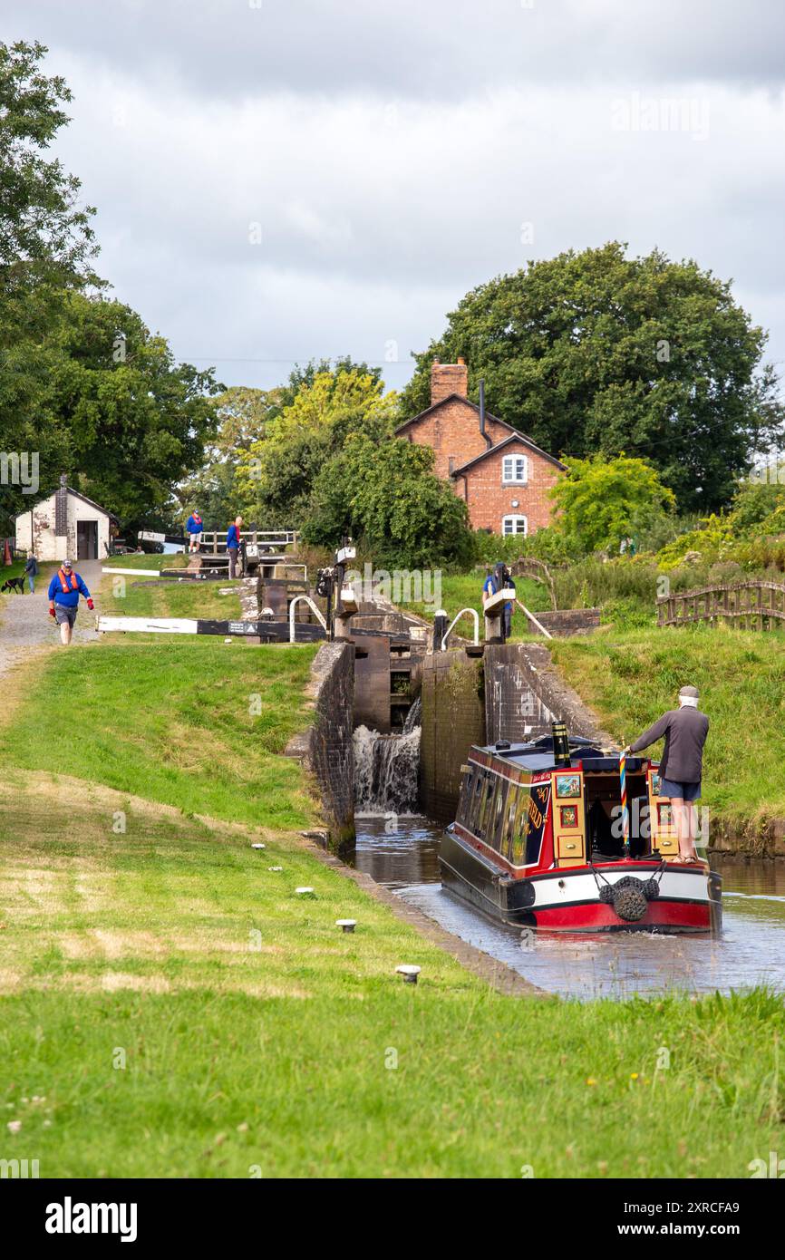 Canal narrowboat passing through Hurleston locks Cheshire on the Llangollen canal  after leaving the Shropshire union canal at its junction. Stock Photo