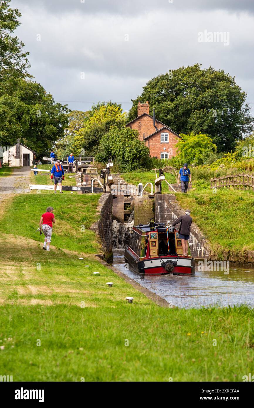 Canal narrowboat passing through Hurleston locks Cheshire on the Llangollen canal  after leaving the Shropshire union canal at its junction. Stock Photo