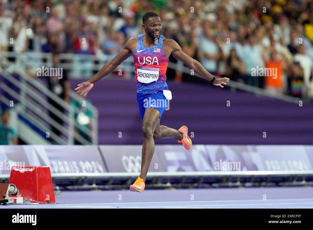 gold medalist Rai Benjamin, of the United States, crosses the finish ...