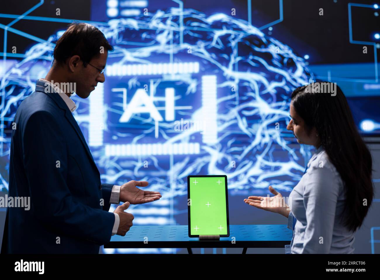 Technician running AI cognitive computing technology on mockup tablet to simulate computerized model. Green screen digital device used by IT employees to do data mining with artificial intelligence Stock Photo