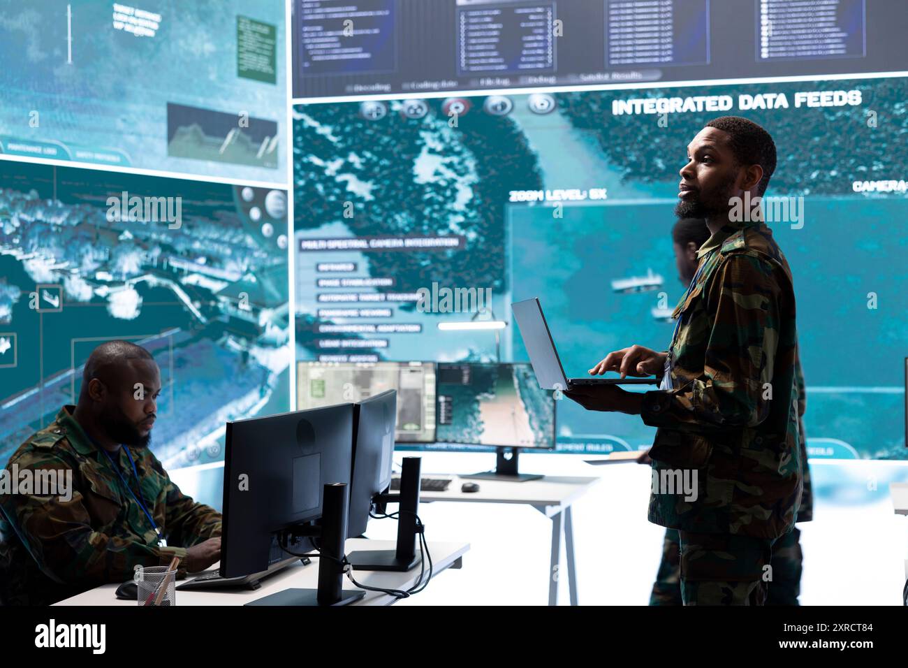 Military control room features army personnel monitoring surveillance ...