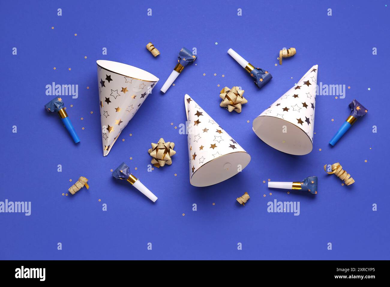 Party hats and whistles on dark blue background Stock Photo - Alamy