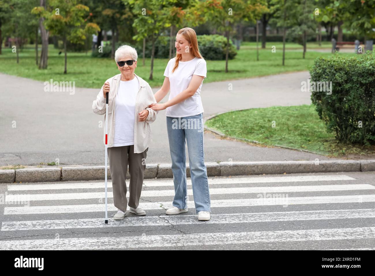 Old woman walking stick crossing hi-res stock photography and images ...