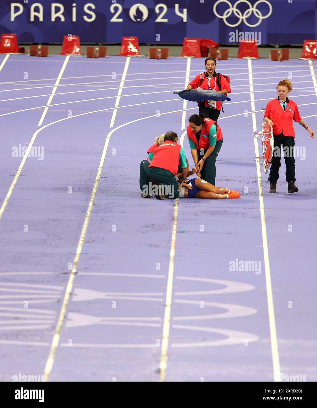 Paris, France. 9th Aug, 2024. Alessia Zarbo of France gets medical attention after falling down during the women's 10000m final of Athletics at the Paris 2024 Olympic Games in Paris, France, Aug. 9, 2024. Credit: Li Ying/Xinhua/Alamy Live News Stock Photo