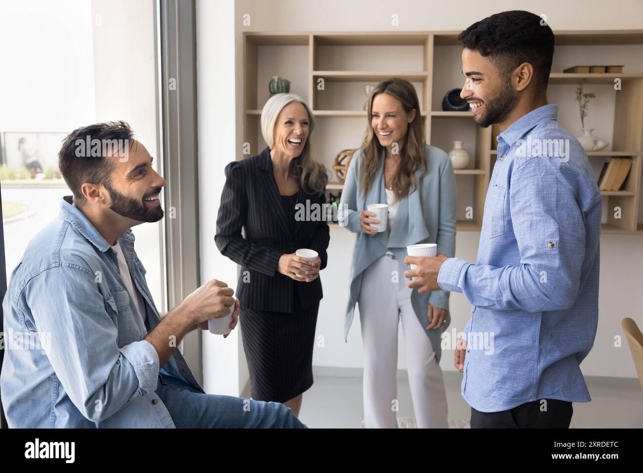 Cheerful diverse business colleagues talking and laughing Stock Photo