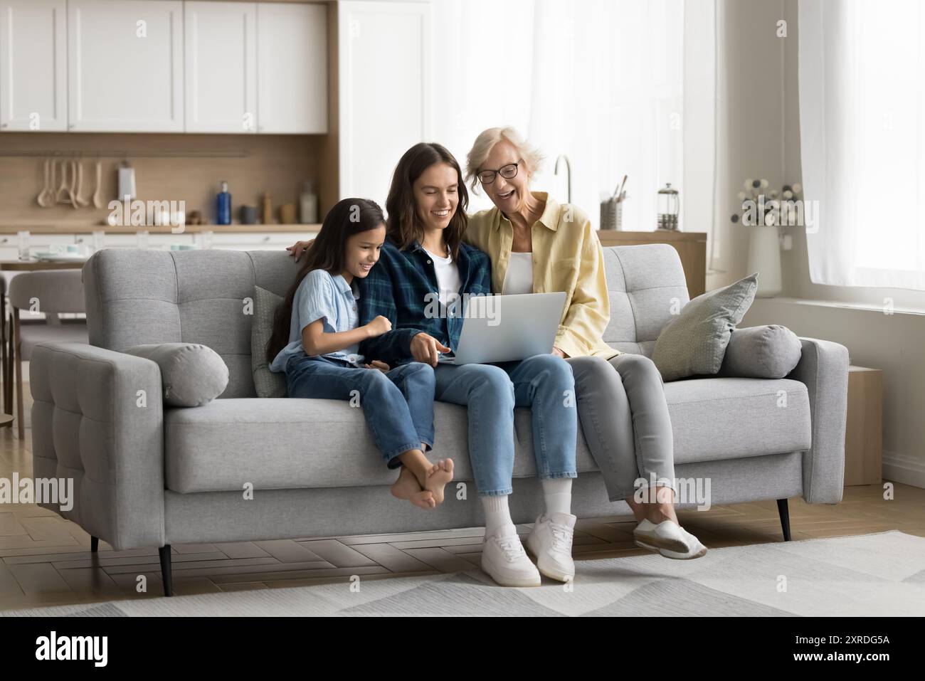 Happy older grandma, mom and cute kid girl using laptop Stock Photo - Alamy