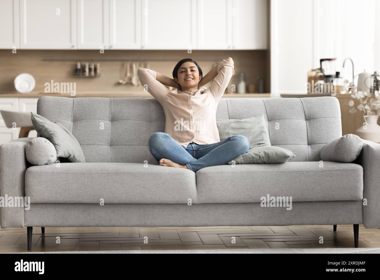 Peaceful Indian woman relaxing on cozy sofa Stock Photo - Alamy