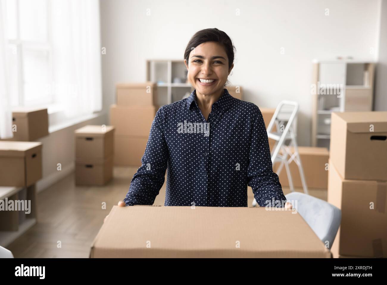 Portrait of successful small business owner holding big carton box Stock Photo