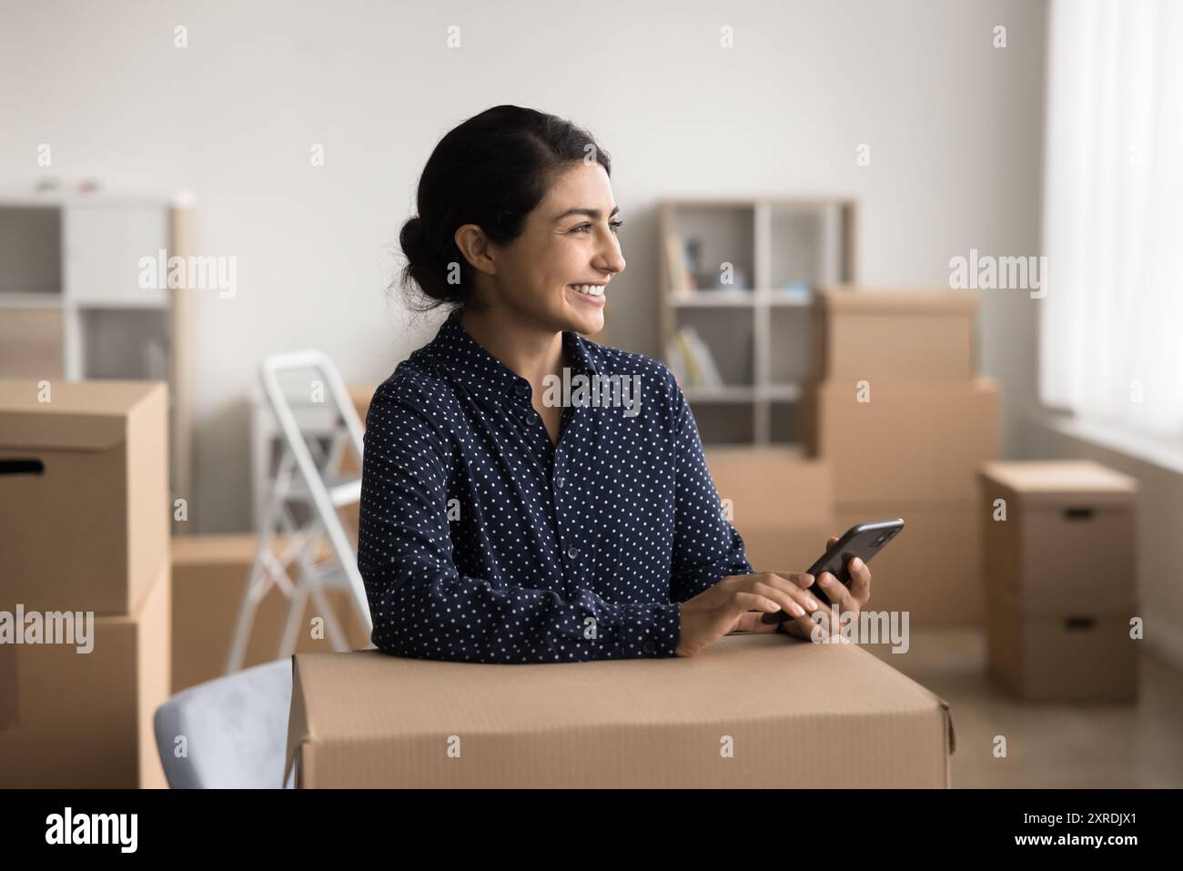 Warehouse worker or small business owner using smartphone Stock Photo