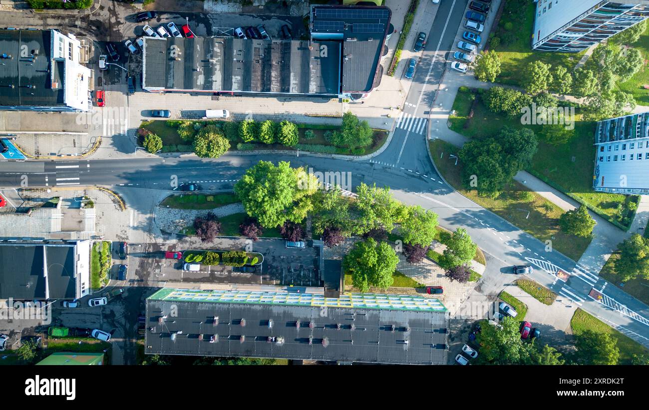 Aerial view of urban streets, green spaces, and parked cars in a modern ...