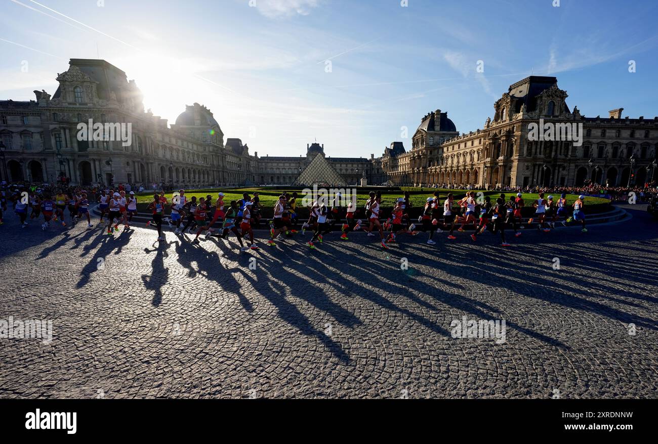 Athletes pass the Louvre Museum during the Men's Marathon on the