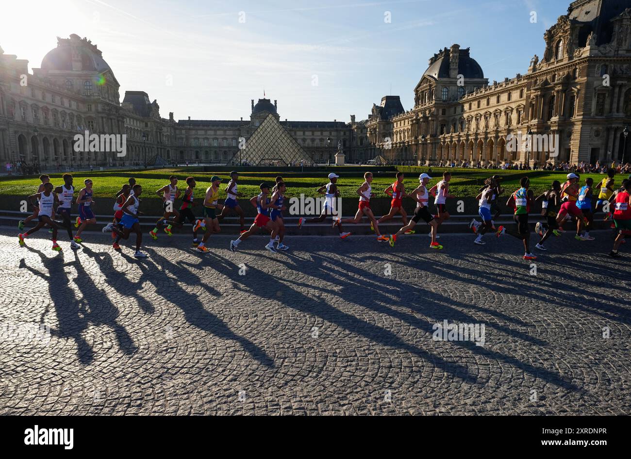 Athletes pass the Louvre Museum during the Men's Marathon on the