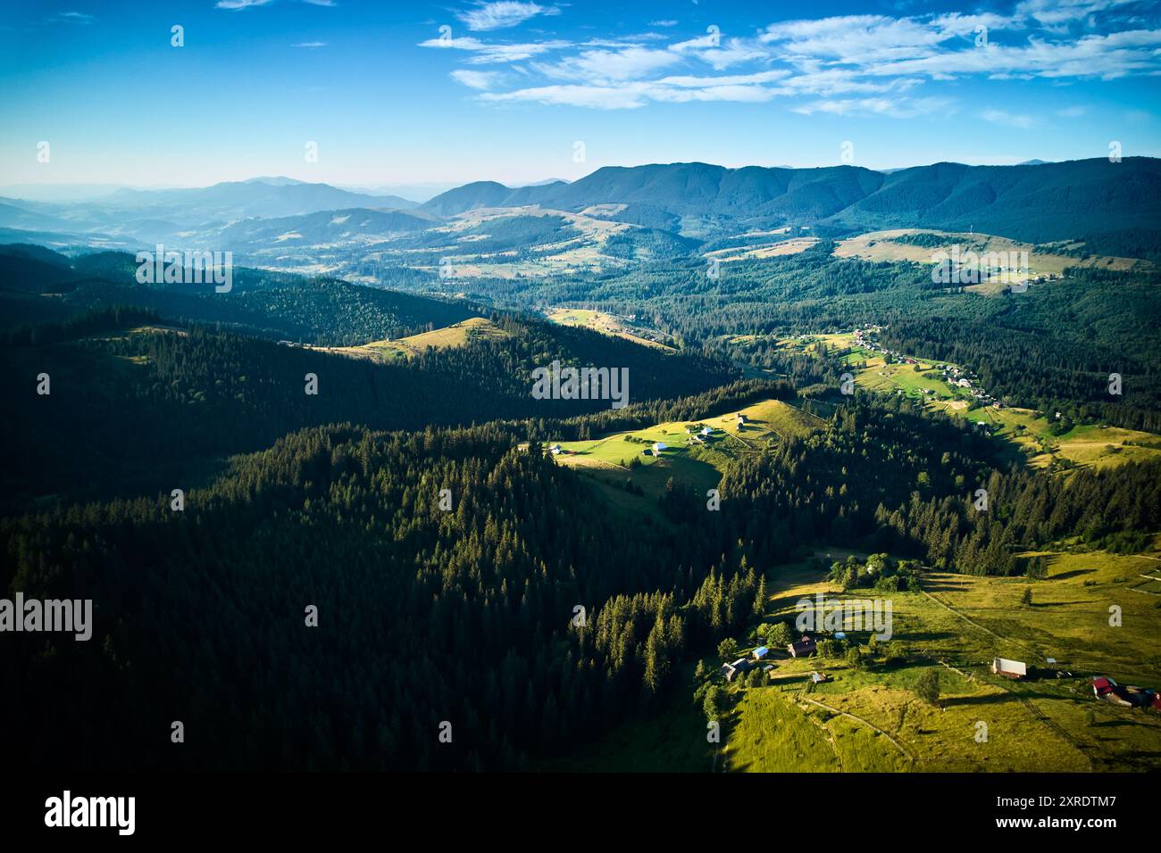 Aerial view of densely forested mountains stretching into distance ...