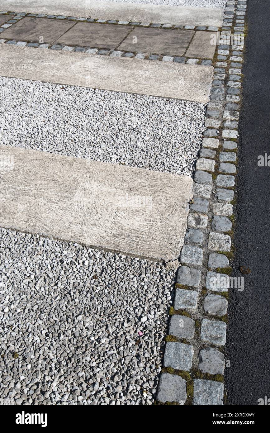 Neat driveway edging using granite steps at the edge of an overall designed area (seen in Settle, North Yorkshire). Stock Photo