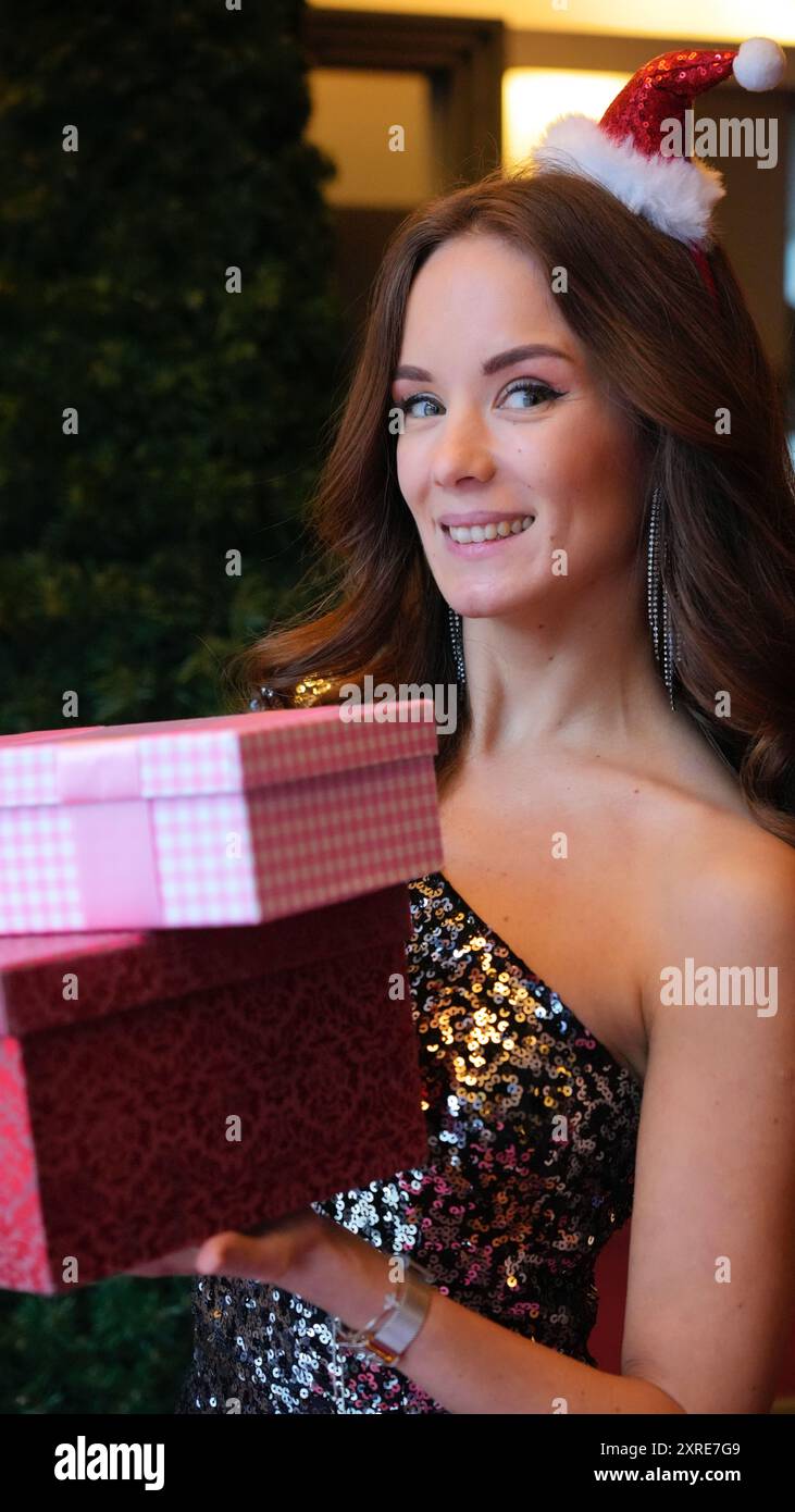 Girl holding Christmas presents. Emotions Stock Photo