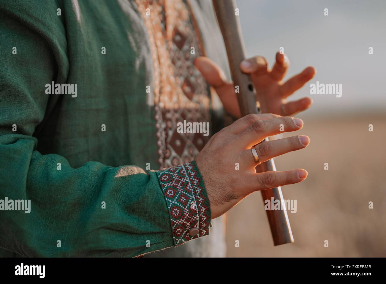 Hands Of Man Playing On Woodwind Wooden Flute - Ukrainian Sopilka Stock Photo