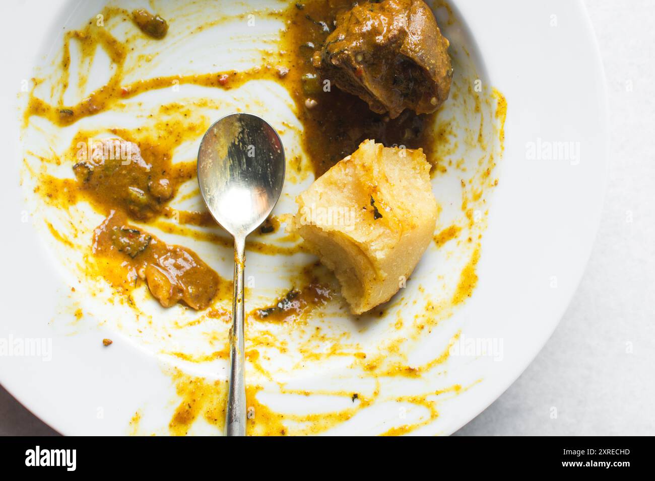 Overhead view of nigerian ogbono soup and eba on a white plate, top ...