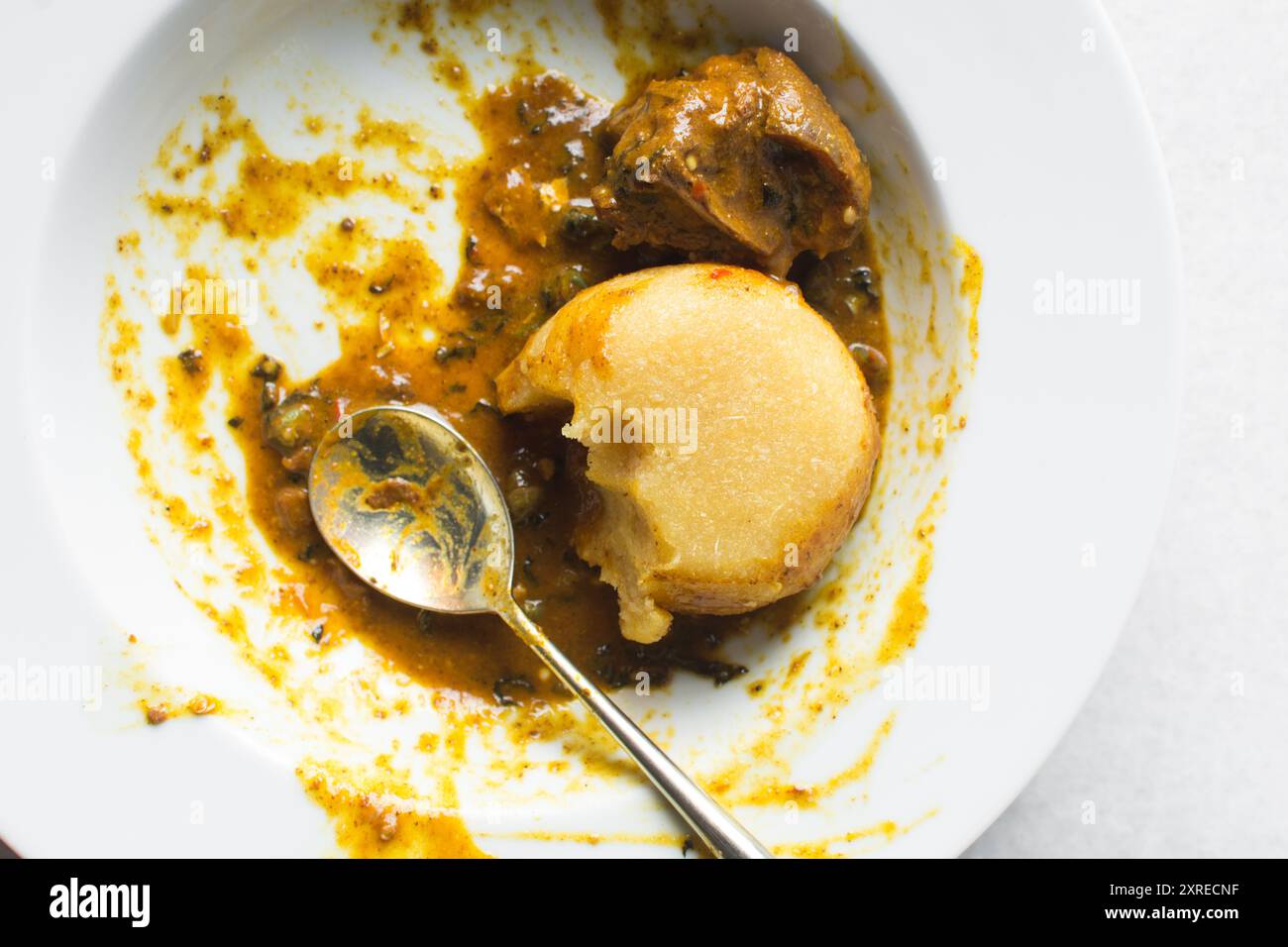Overhead view of nigerian ogbono soup and eba on a white plate, top ...