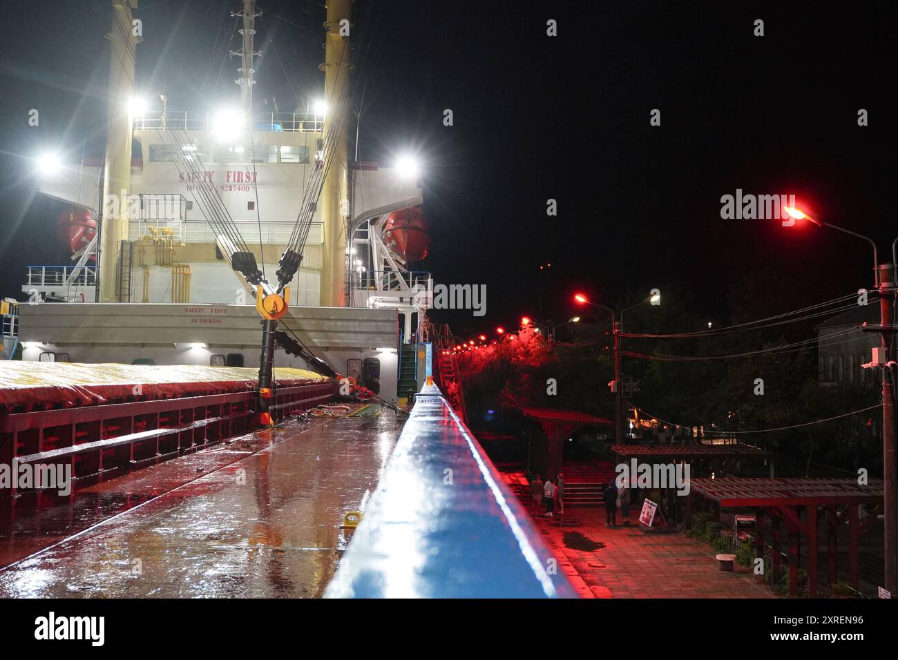 Nighttime View Along the Deck of a Docked Cargo Ship in Sulina, Romania Stock Photo