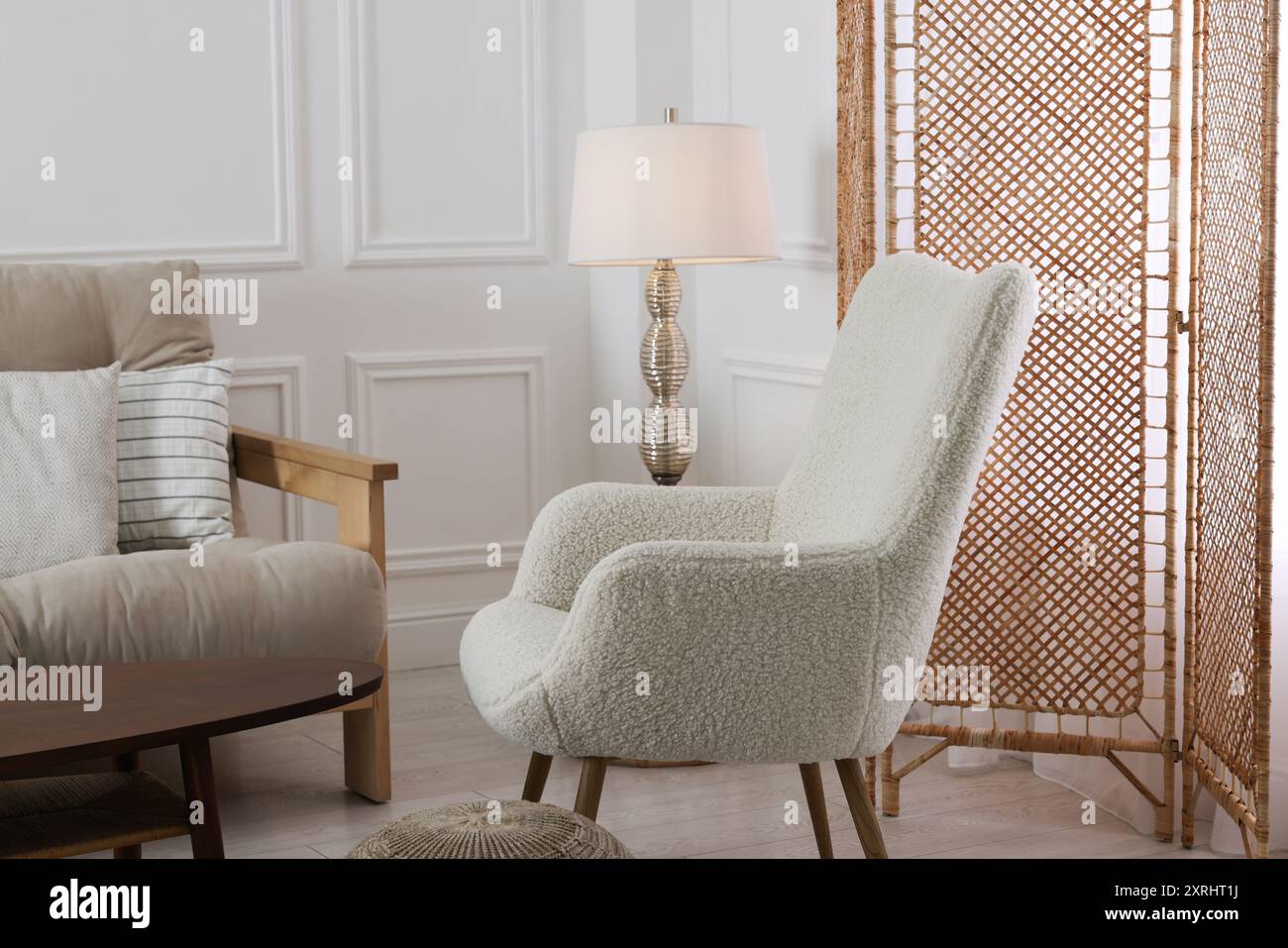 Folding screen, armchair and lamp in room Stock Photo - Alamy