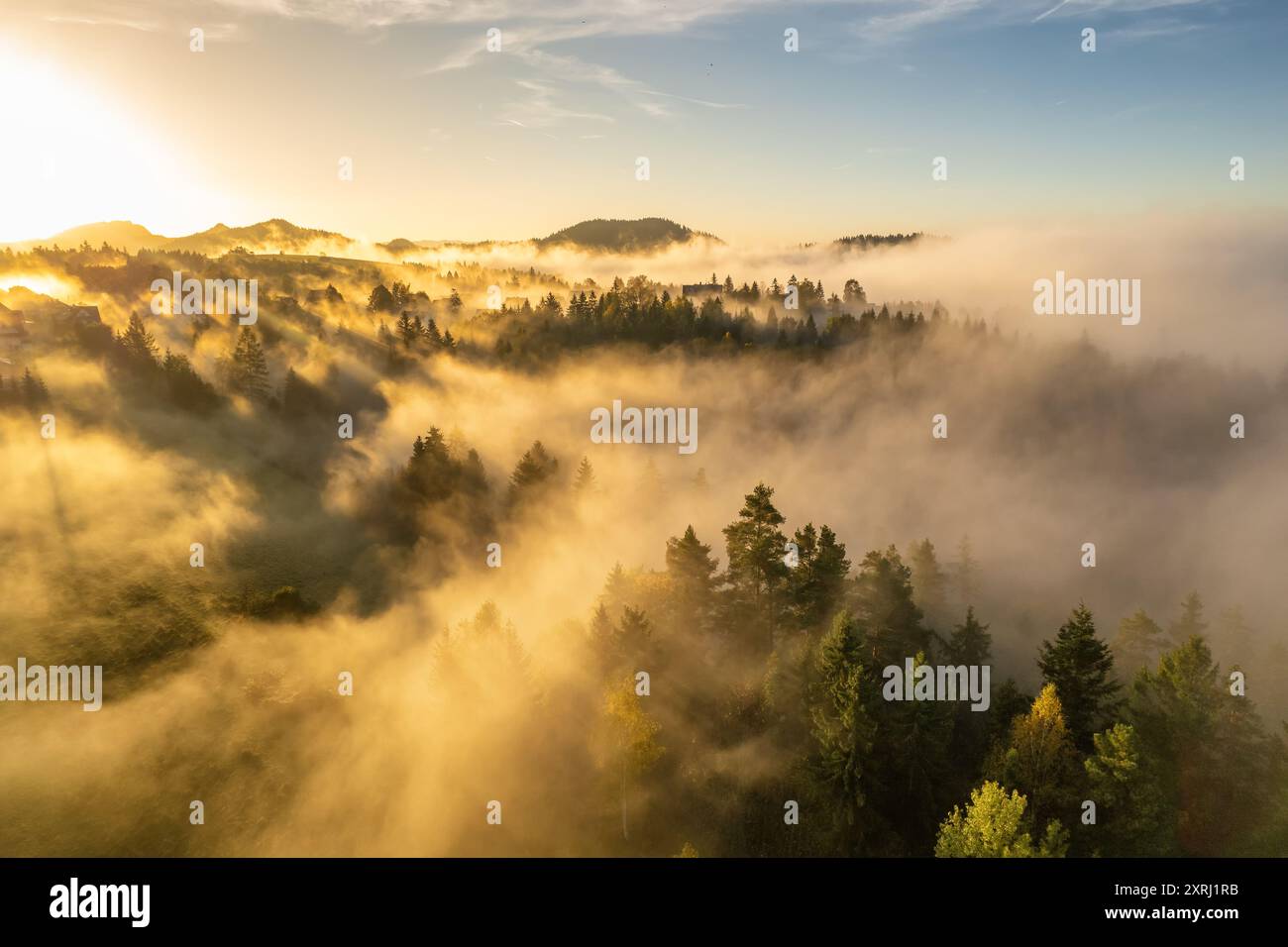 Aerial view of a mountain landscape shrouded in morning fog during ...