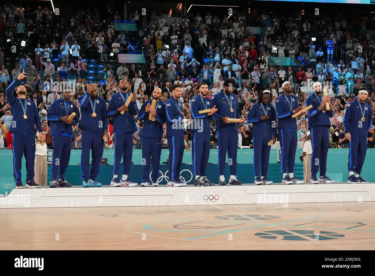 Team USA celebrate with their gold medals on the podium after defeating ...