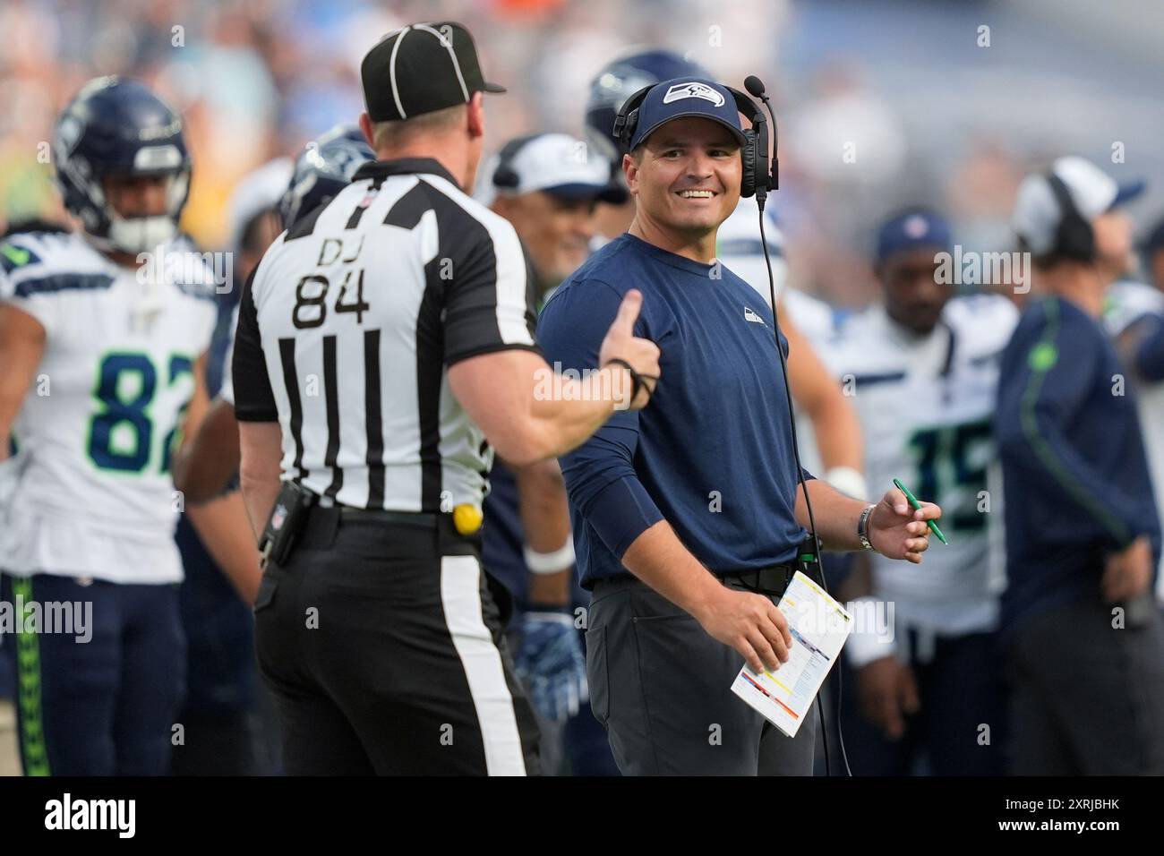 Seattle Seahawks head coach Mike Macdonald, right, talks to official Jay  Bilbo (84) during the first half of a preseason NFL football game against  the Los Angeles Chargers in Inglewood, Calif., Saturday,
