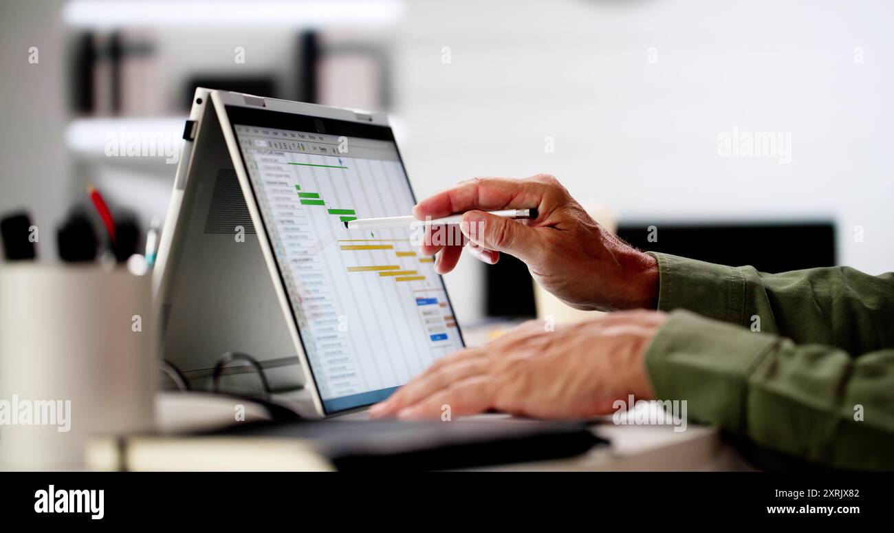Project Management Software And Business Plan Schedule In Office Stock Photo