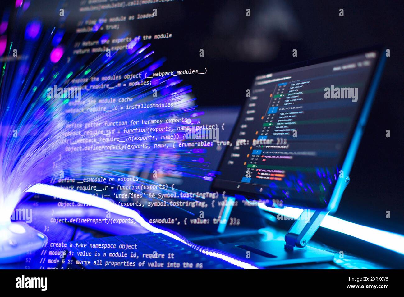 Program code on a computer monitor with fiber optic background ...