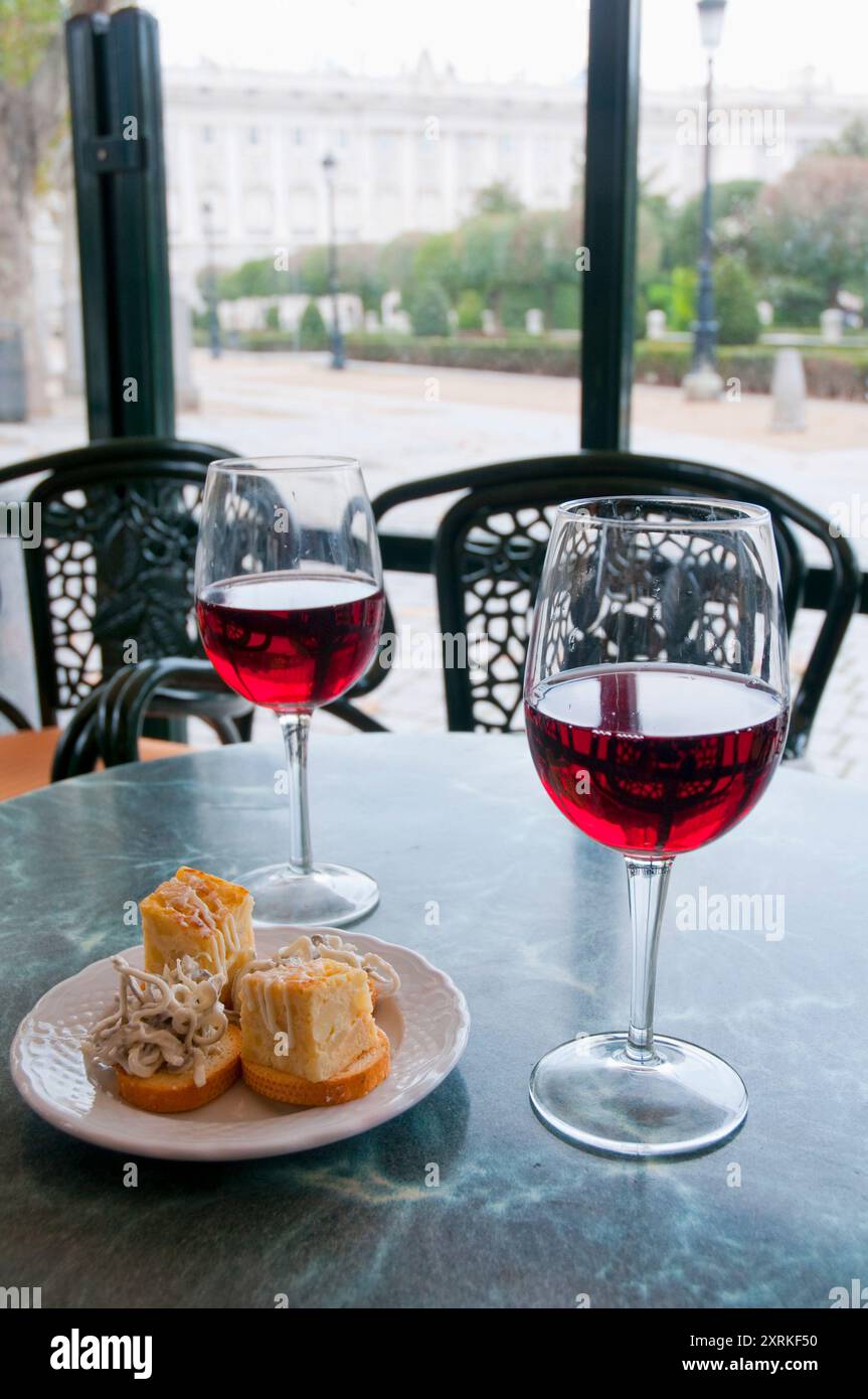 Two glasses of rose wine with tapa of Spanish omelet and gulas. Madrid, Spain. Stock Photo