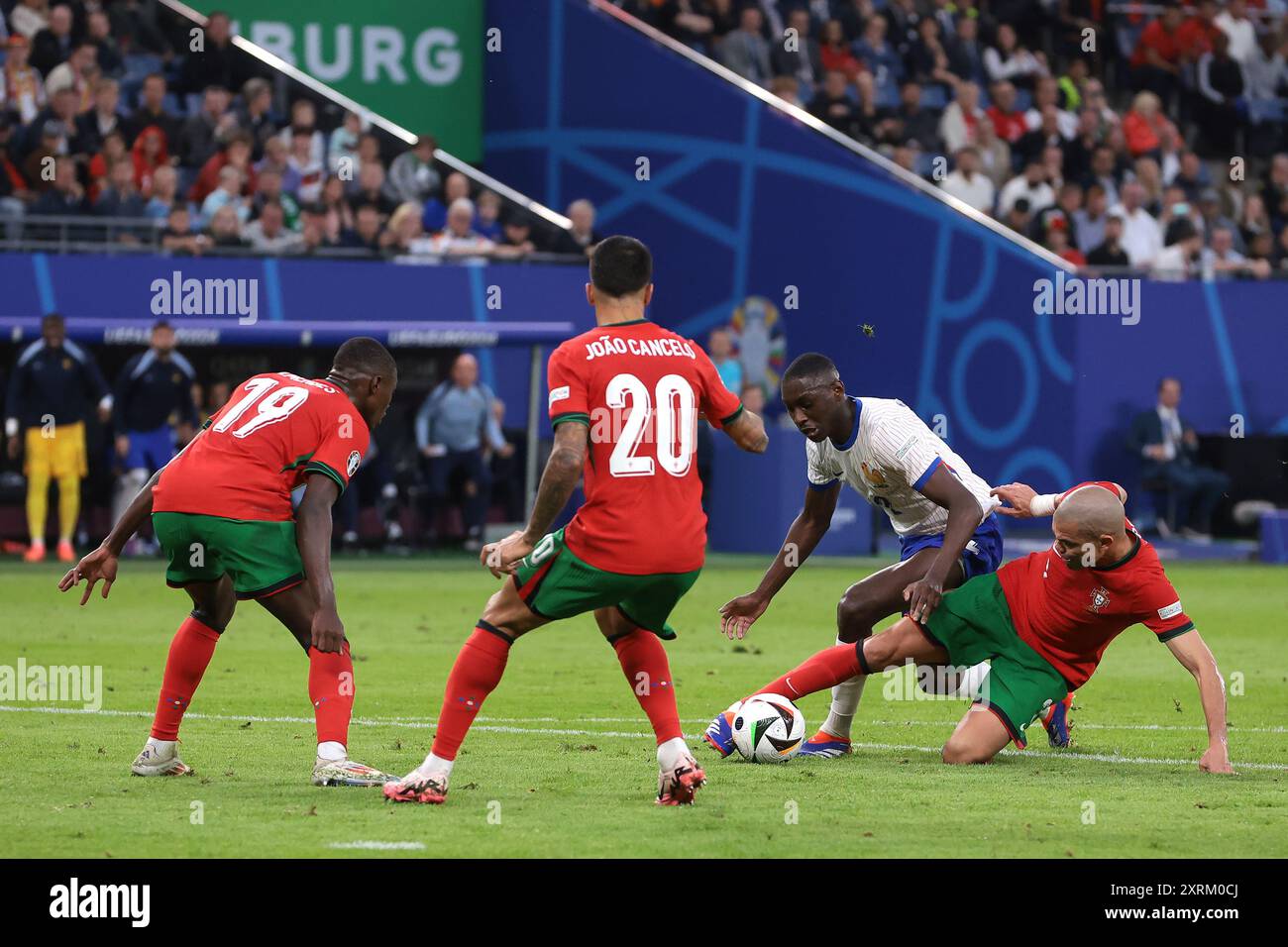 Hamburg, Germany. 5th July, 2024. Nuno Mendes and Joao Cancelo of Portugal look on as team mate Pepe dispossesses Randal Kolo Muani of France on the edge of the penalty area during the UEFA European Championships quarter final match at Volksparkstadion, Hamburg. Picture credit should read: Jonathan Moscrop/Sportimage Credit: Sportimage Ltd/Alamy Live News Stock Photo