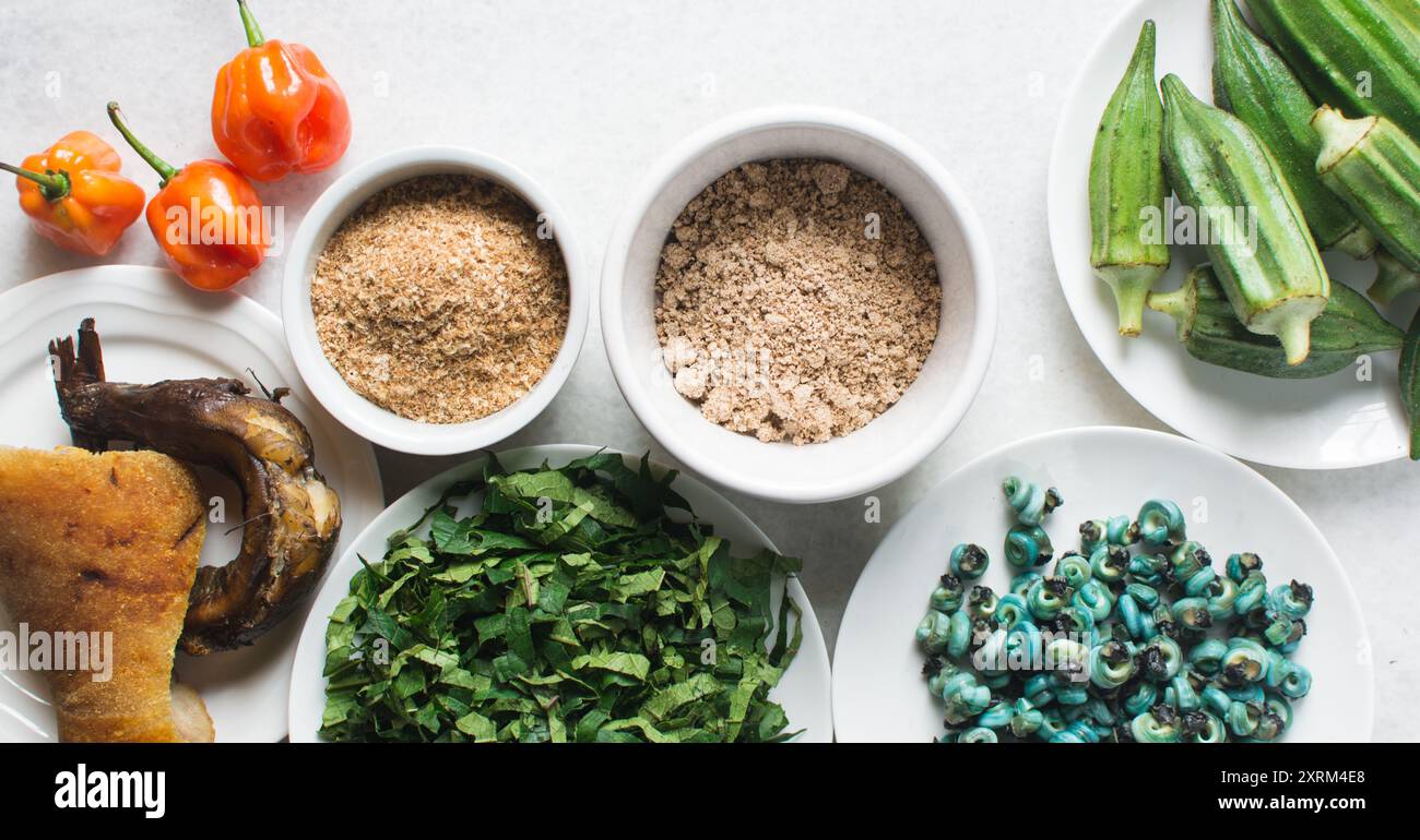 Overhead view of ingredients for making ogbono soup on a granite countertop, top view of mise en place of ingredients for making ogbono and okro soup, Stock Photo