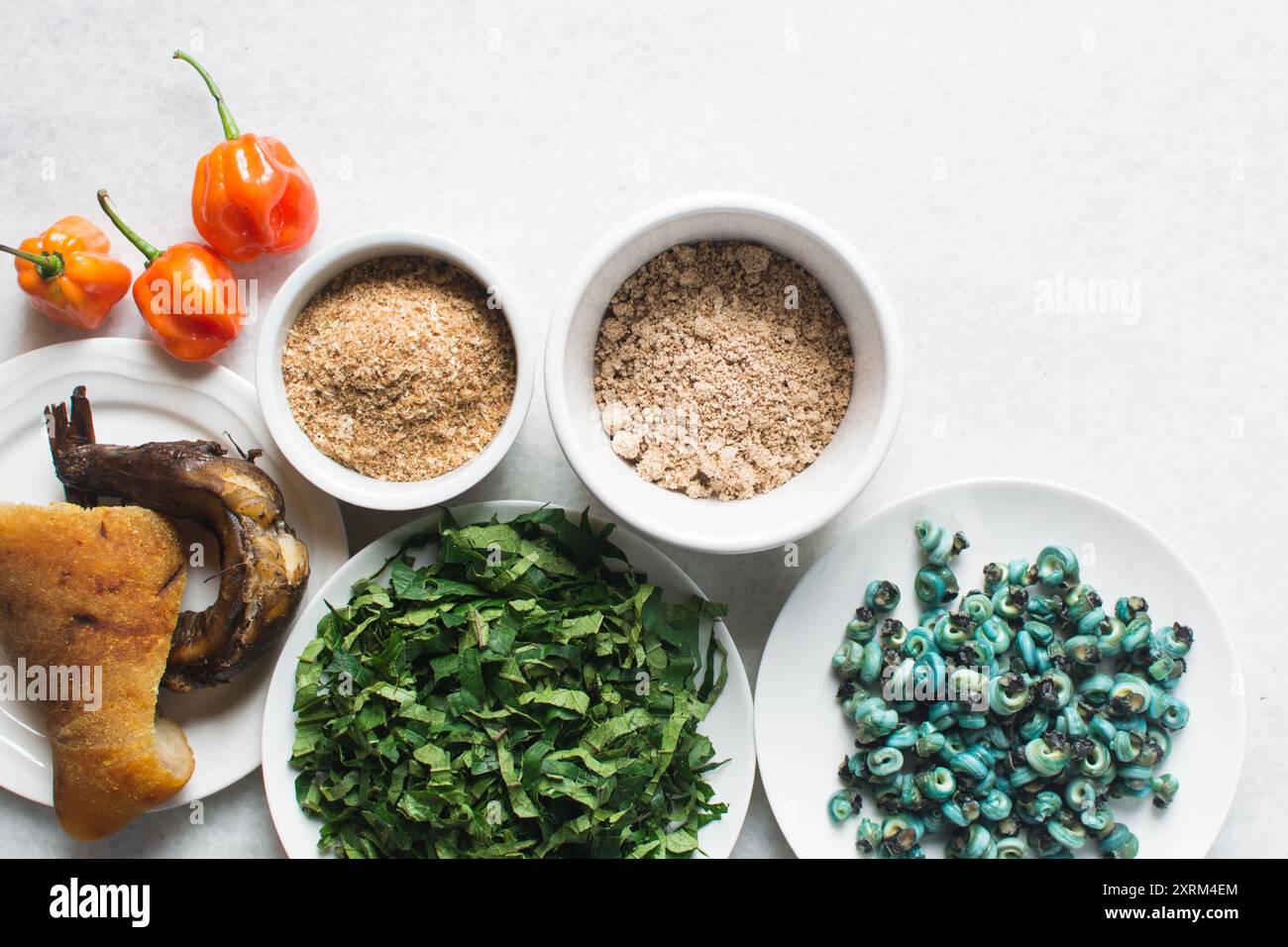 Overhead view of ingredients for making ogbono soup on a granite countertop, top view of mise en place of ingredients for making ogbono and okro soup, Stock Photo