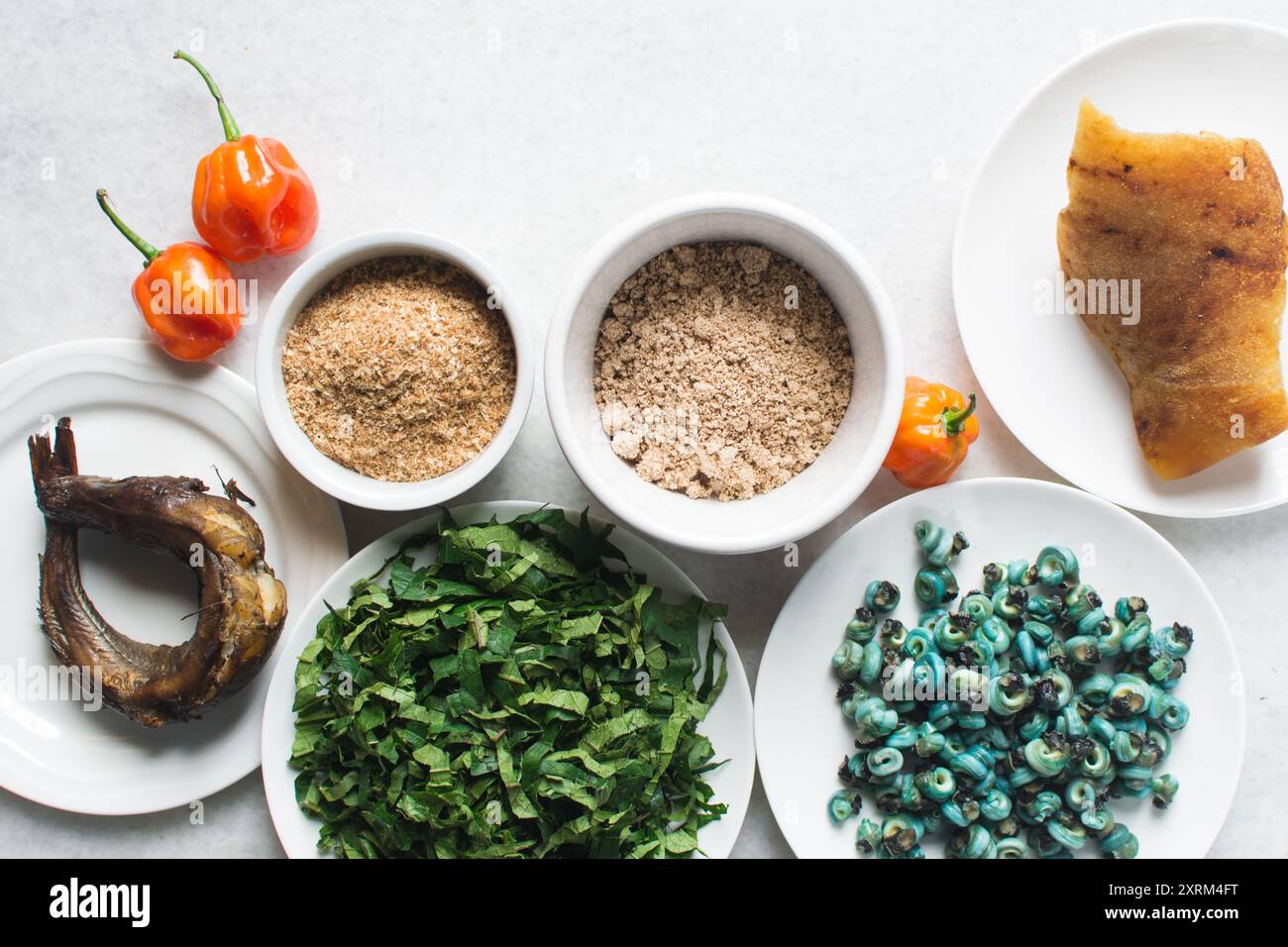 Overhead view of ingredients for making ogbono soup on a granite countertop, top view of mise en place of ingredients for making ogbono and okro soup, Stock Photo
