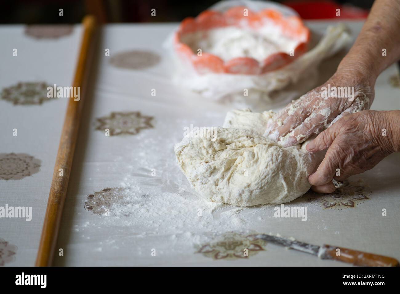 Old woman kneading dough bread hi-res stock photography and images - Alamy