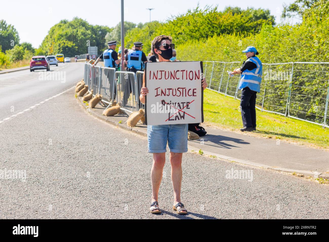 Selby, UK. 11 AUG, 2024. Lady carries 'Injunction Injustice' sign as around 50 protestors gathered to demonstrate against Drax power station, they claim that the stations use of 'wood pellets' as a replacement for coal is causing mass deforestation, this comes as Drax was granted an injunction against climate protestors and 22 members of group Reclaim the Power were pre-emptively arrested ahead of a planned multi-day squat at Drax. Credit Milo Chandler/Alamy Live News Stock Photo