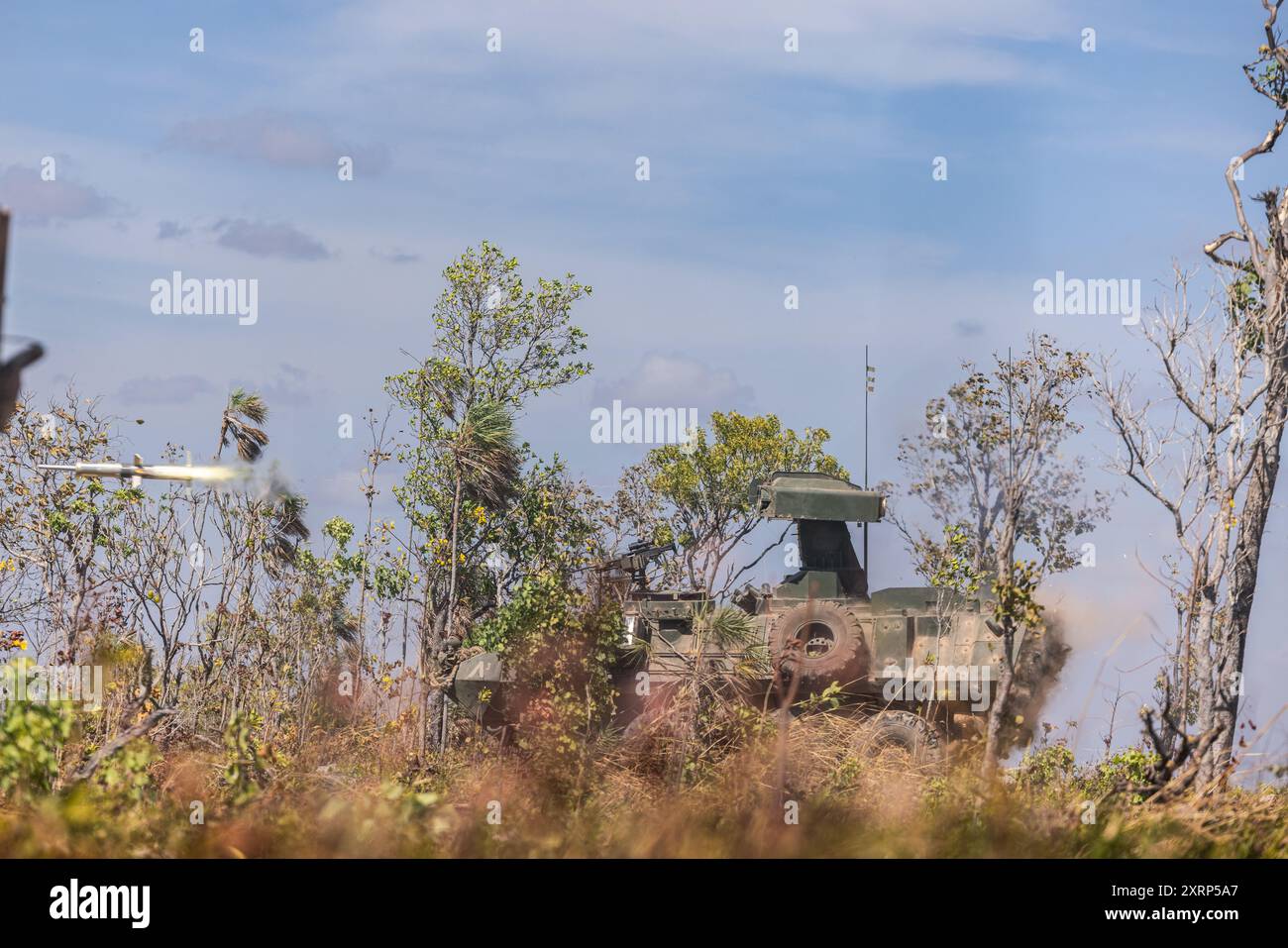 U.S. Marines with Alpha Company, 1st Light Armored Reconnaissance Battalion, 1st Marine Division, fire a BGM-71 TOW missile from an LAV-Anti Tank Light Armored Vehicle as part of a combined arms live-fire exercise during Exercise Predator’s Run 24 at Mount Bundey Training Area, NT, Australia, Aug. 5, 2024. During Rapid Deployment Exercise, 1st LAR rapidly deployed from Marine Corps Base Camp Pendleton, California, U.S., to Australia by strategic lift and rail to participate in the 1st Brigade, Australian Army led, Exercise Predator’s Run 24. Exercise Predator’s run 24 provides Marine Rotationa Stock Photo