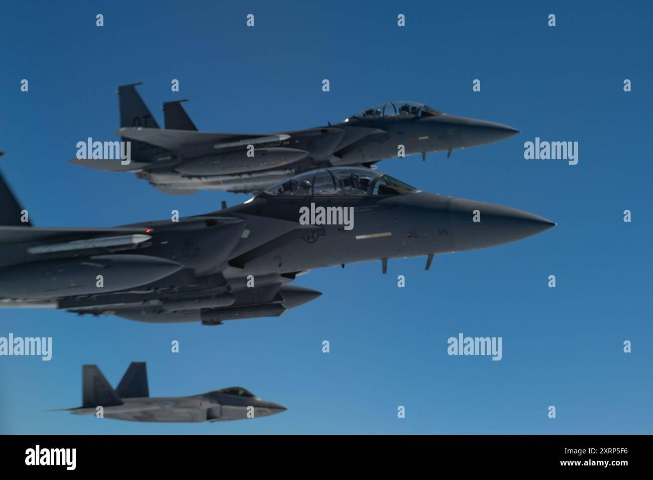 U.S. Air Force F-15E Strike Eagles and an F-22 Raptor assigned to the ...