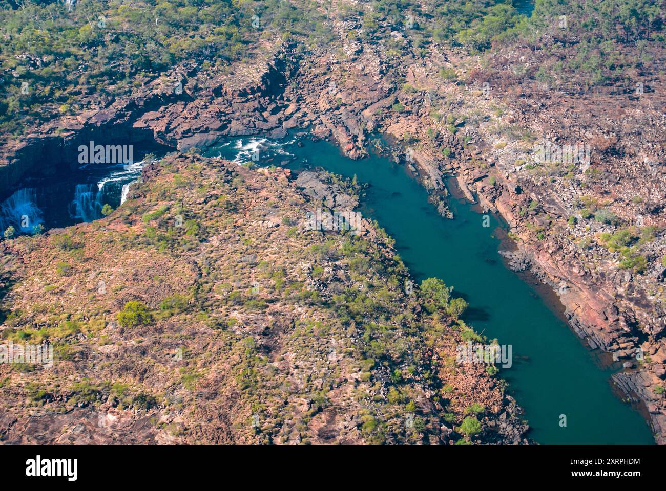 Mitchell river flowing towards Mitchell Falls through its riverbed of red rocks, Kimberleys, Western Australia, aerial view Stock Photo