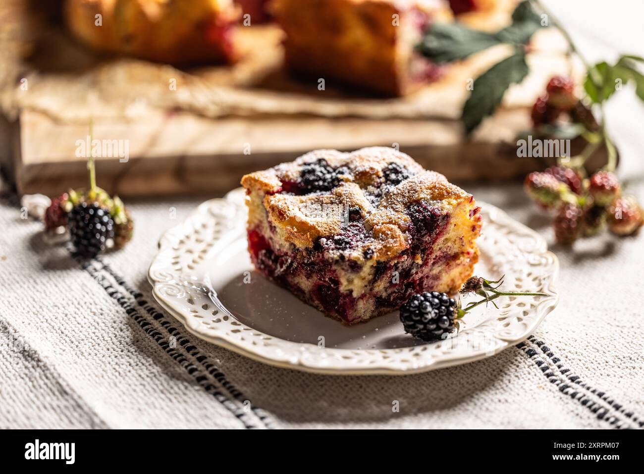 Fresh and hot blackberry cake made of blackberries, flour and eggs. Vegan fruit sponge cake. Stock Photo