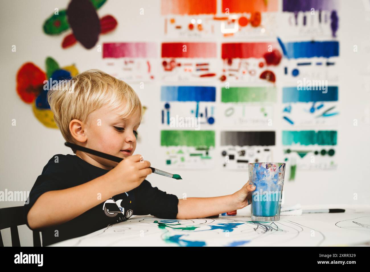 Cute child painting with watercolors in art studio Stock Photo - Alamy