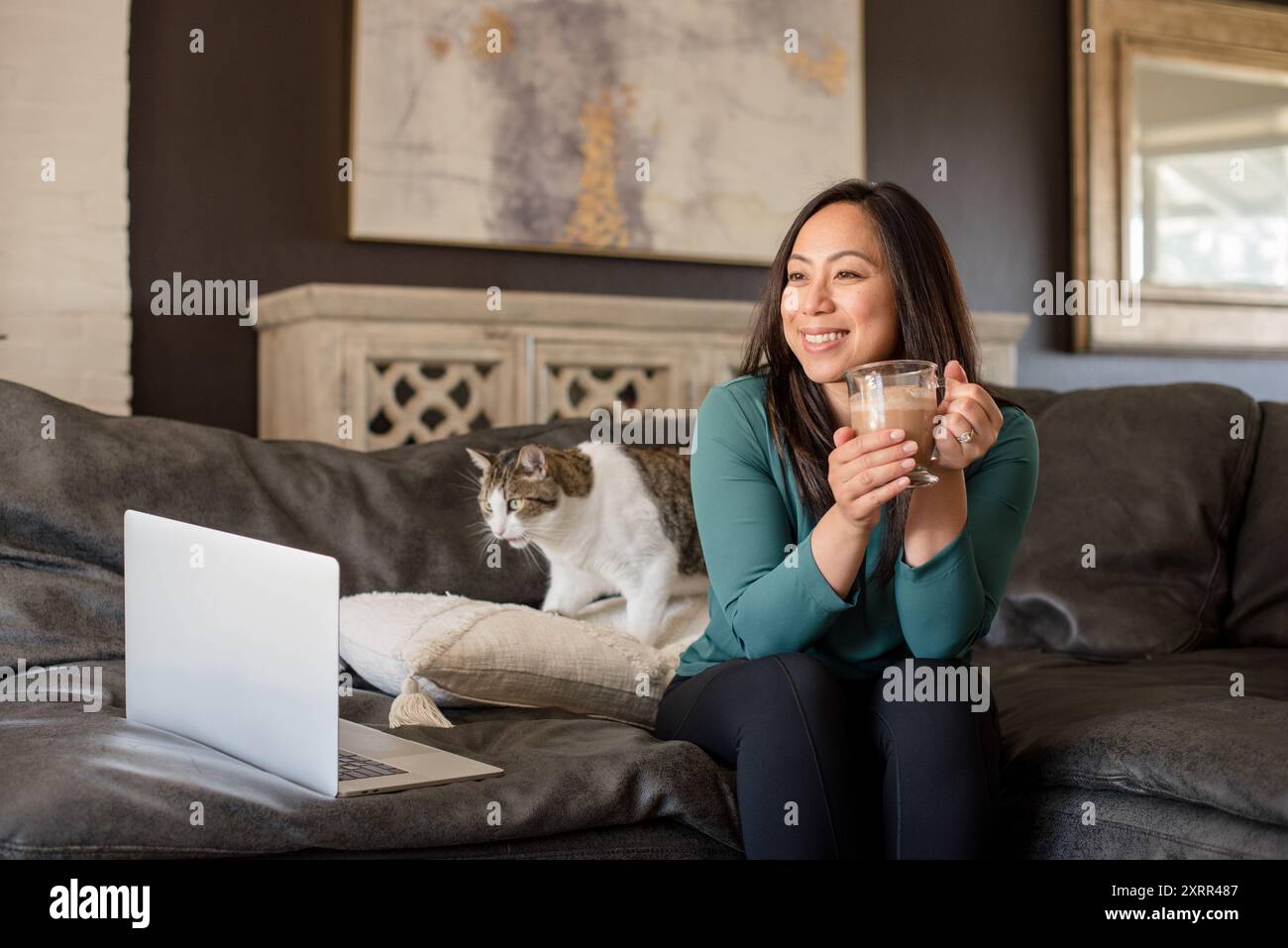 Asian woman sitting on couch hi-res stock photography and images - Alamy
