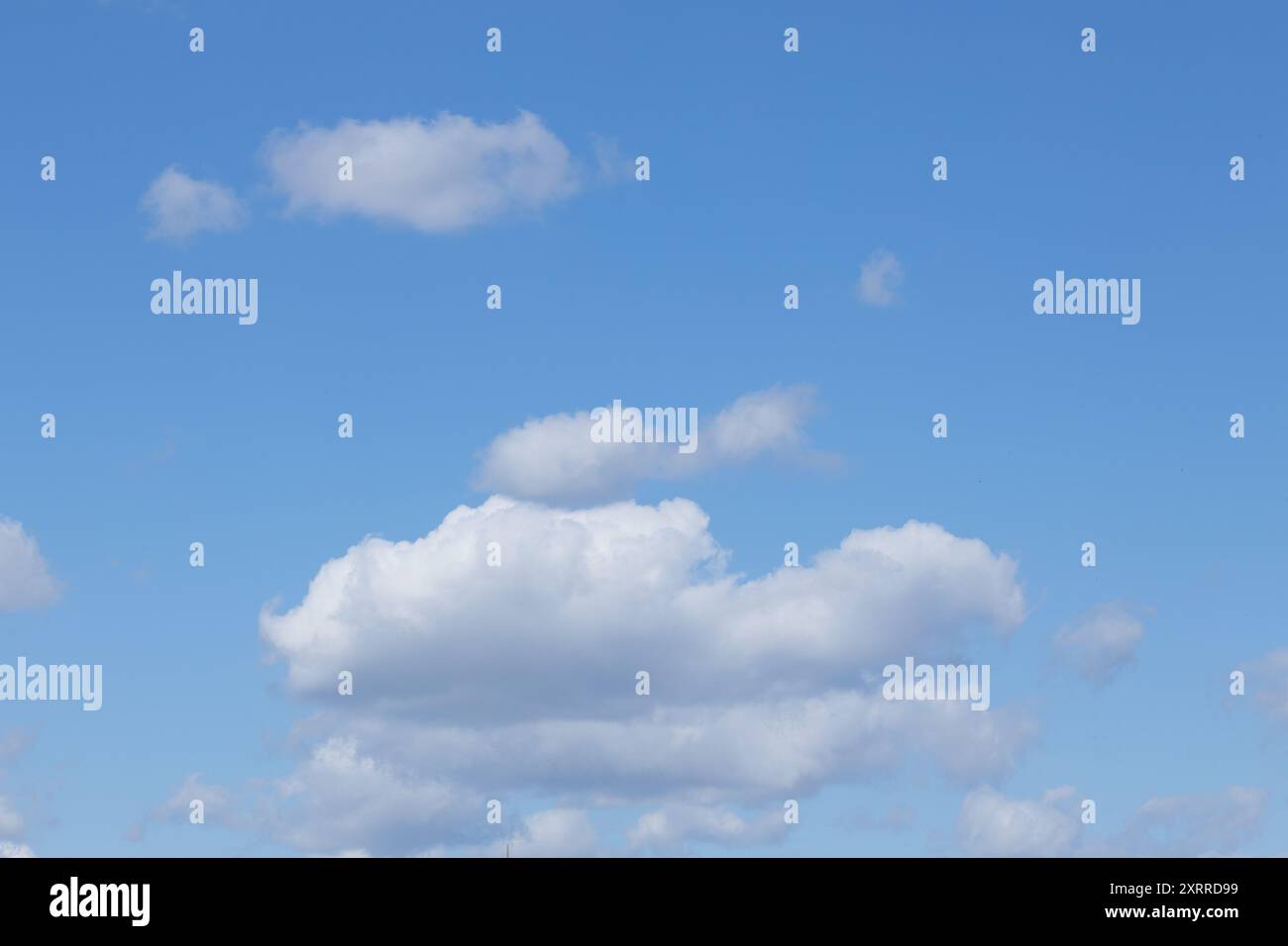 Clear Blue Sky with Fluffy White Clouds Stock Photo